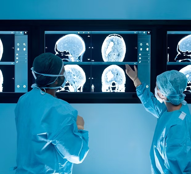 Two doctors review MRI imaging of brain damage