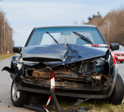A car with a damaged front fender after a car accident