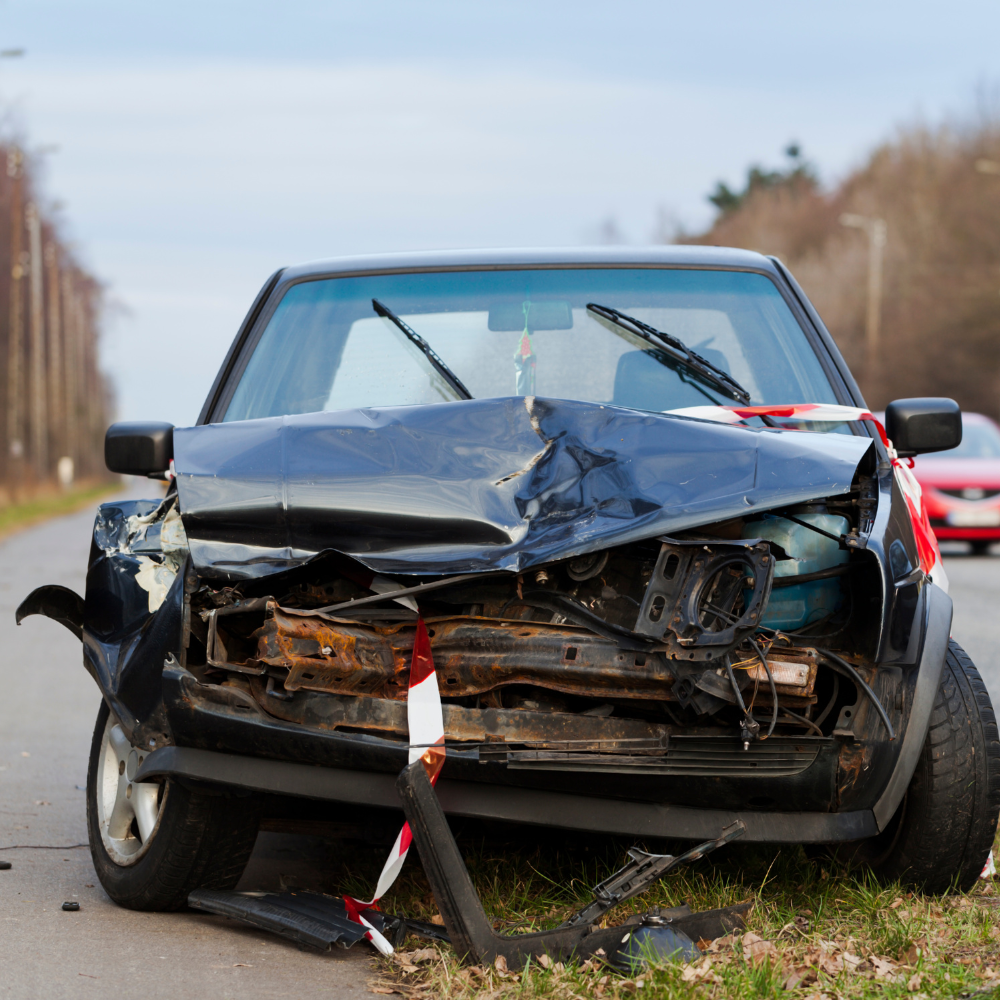 A car with a damaged front fender after a car accident