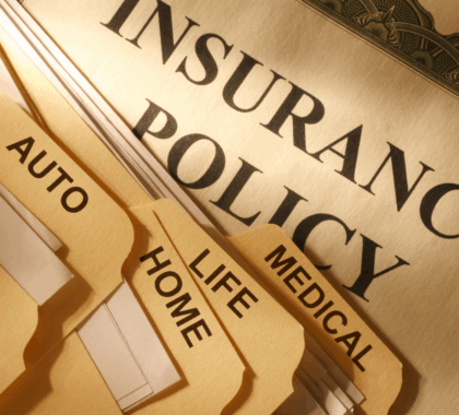 Manilla folders titled Insurance Policy, Medical, Life, Home, and Auto
