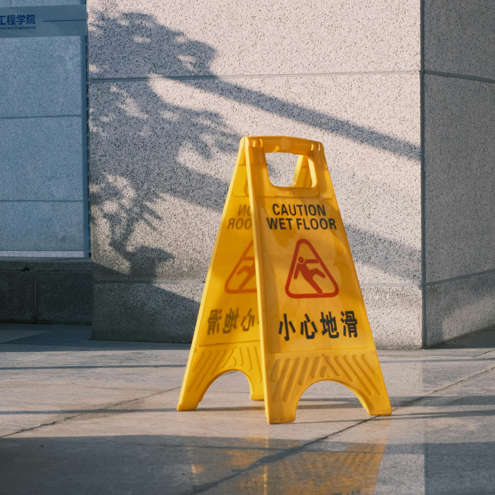 A caution sign indicating a fall risk due to wet floor