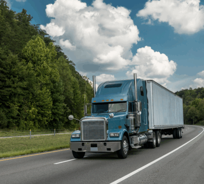 An 18-wheel truck driving down the road
