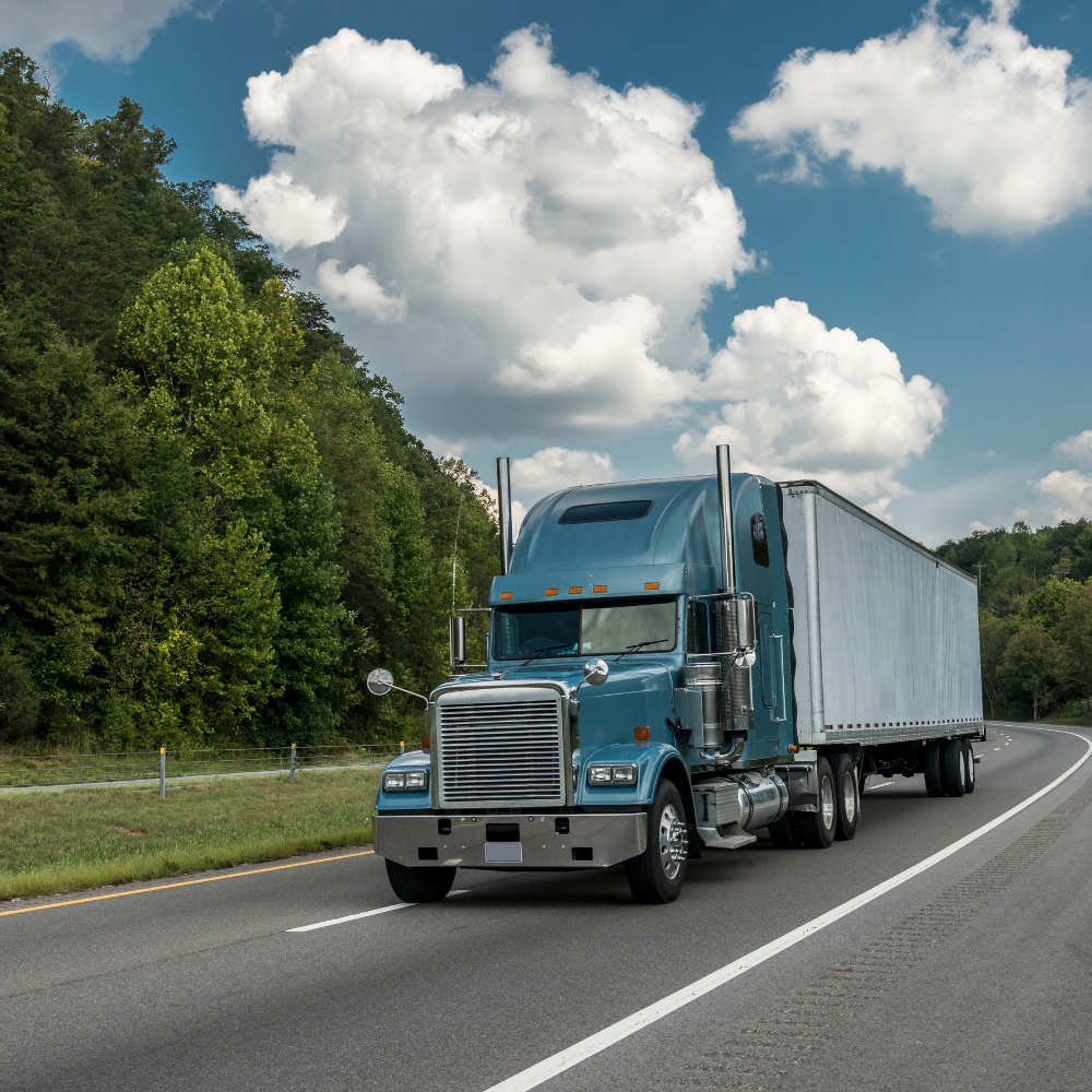 An 18-wheel truck driving down the road