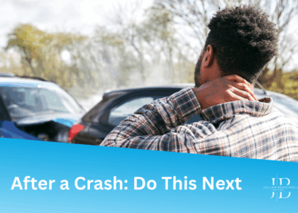 A man rubs his neck in pain after a rear-end collision