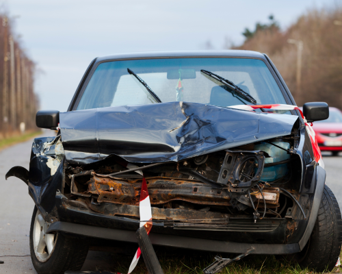 A car with a damaged front fender after a car accident