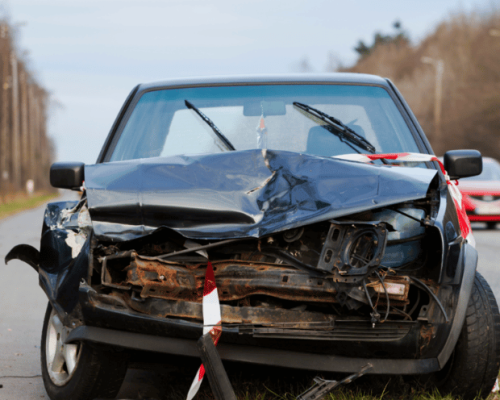 A car with a damaged front fender after a car accident